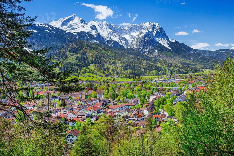 View of the village in spring in front of the Zugspitzgruppe 2962m in the Wetterstein Mountains, Garmisch-Partenkirchen, Loisachtal, Werdenfelser Land, Bavarian Alps, Upper Bavaria, Bavaria, Germany, Europe