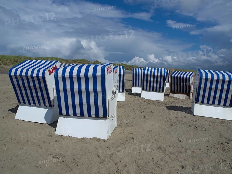 Blue and white beach chairs on the beach in front of dunes and a cloudy sky, blue and white striped beach chairs on the beach, Norderney, Germany, Europe