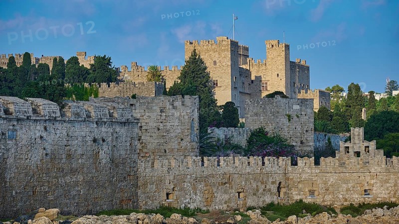 Ancient fortress walls with battlements, surrounded by lush greenery under a partly cloudy sky, part of the city wall, Grand Master's Palace, Knights' Town, Rhodes Town, Rhodes, Dodecanese, Greek Islands, Greece, Europe