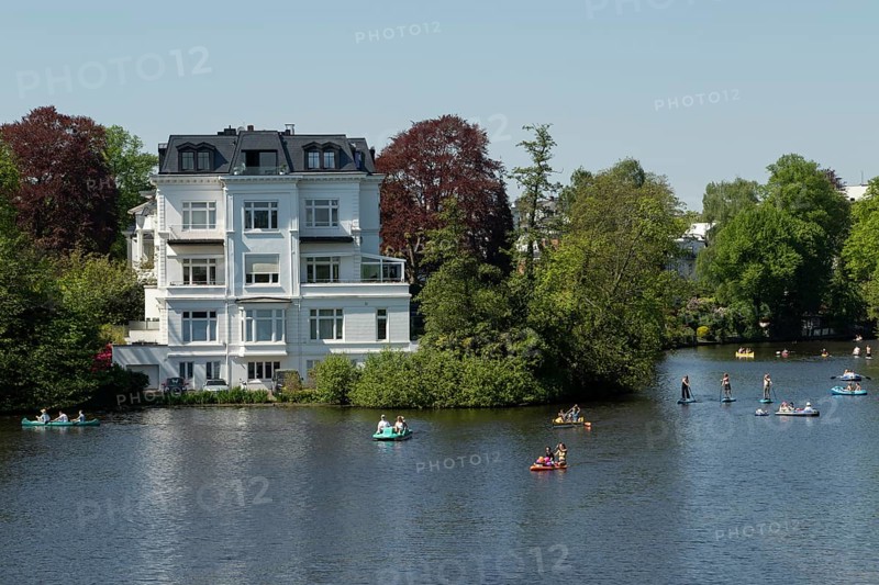 Symbolic picture weather, leisure activity, summery spring, villa at the Krugkoppelbruecke with rowing boats, pedal boats and stand up paddling in front of a blue sky on the Alster in Hamburg, Germany, Europe