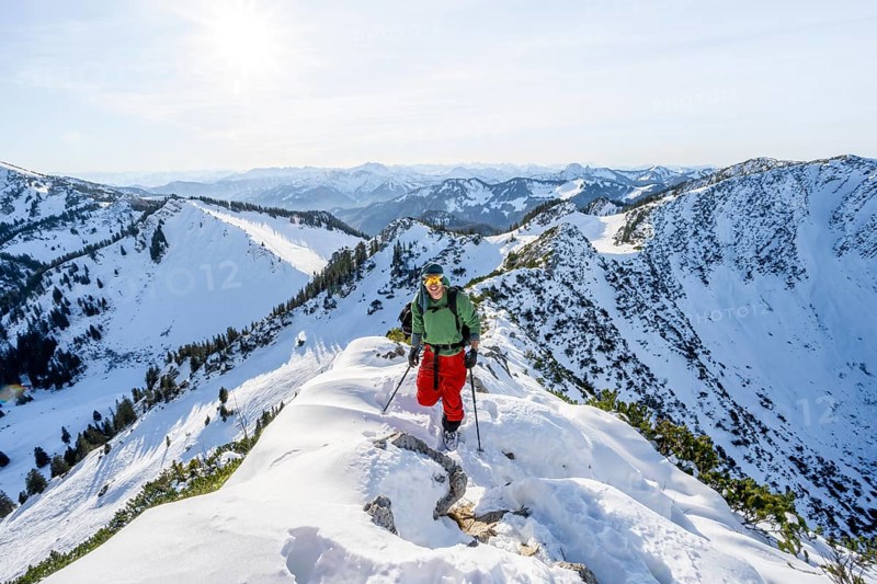 Mountaineer on the ridge of the Aiplspitz in the snow, snow-covered mountain landscape with mountain pines in winter, ski tour to the Aiplspitz, Mangfall mountains, Bavarian Prealps, Bavaria, Tyrol
