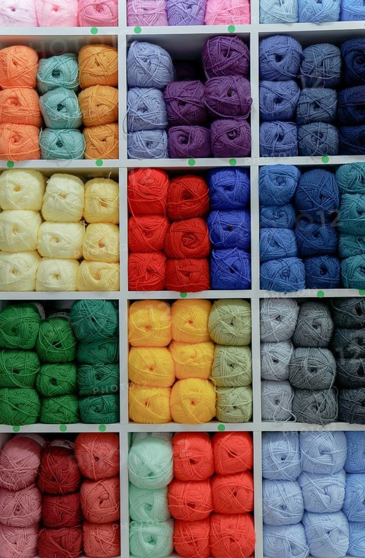 Colorful yarn and wool balls on display in a craft store