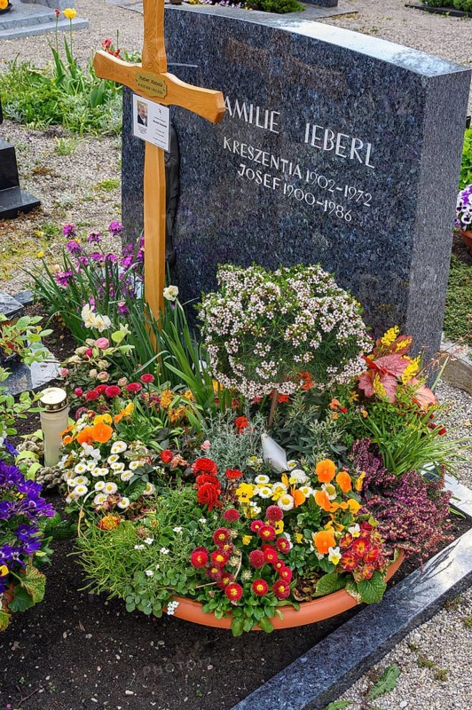 Grave with floral decoration at the cemetery church of St Stephan, Irsee, Swabia, Bavaria, Germany, Europe