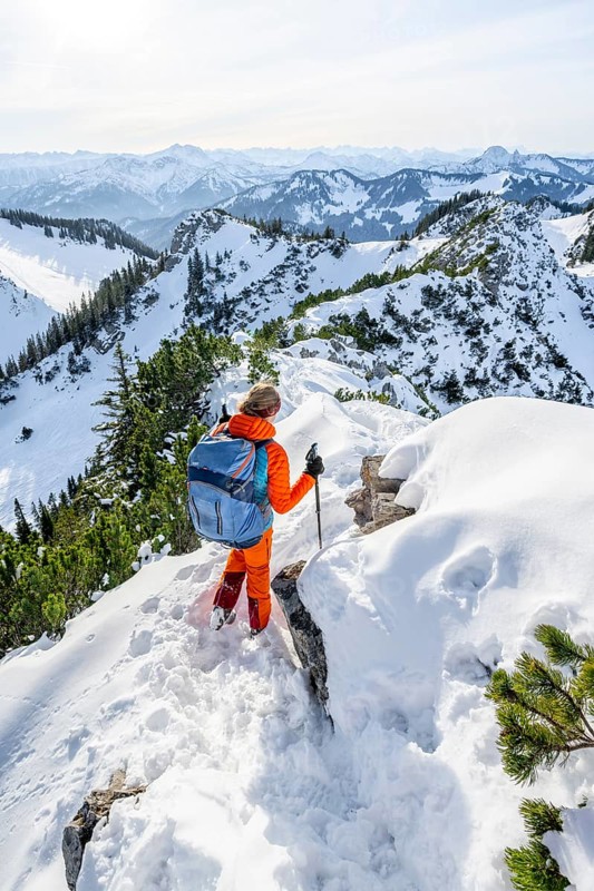 Hiker in winter climbing the Aiplspitz, Mangfall mountains, Bavarian Prealps, Bavaria, Tyrol, Germany, Europe