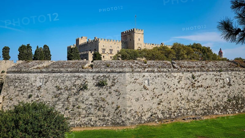 View of a castle across a large stone fortress wall, against a blue sky, Grand Master's Palace, Knights' Town, Rhodes Town, Rhodes, Dodecanese, Greek Islands, Greece, Europe