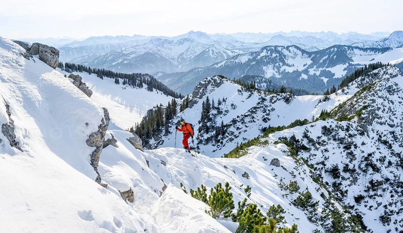 Mountaineer on the ridge of the Aiplspitz in the snow, snow-covered mountain landscape with mountain pines in winter, ski tour to the Aiplspitz, Mangfall mountains, Bavarian Prealps, Bavaria, Tyrol
