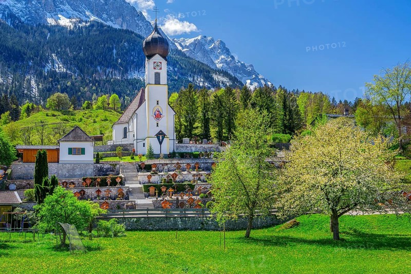 Spring meadow with blossoming trees and parish church in front of the Zugspitze 2962m in the Wetterstein mountains, Zugspitz village Grainau, Werdenfelser Land, Bavarian Alps, Upper Bavaria, Bavaria, Germany, Europe