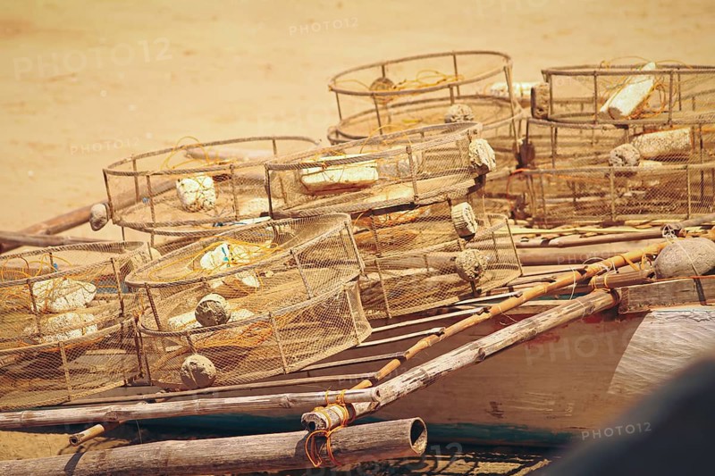 Traditional circular fish traps made from sturdy metal frame and plastic nets left to dry in the sun after being used showing the local source of food and income of the fishermen in the Philippines