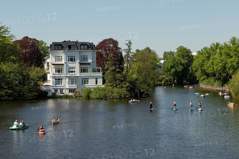 Symbolic picture weather, leisure activity, summery spring, villa at the Krugkoppelbruecke with rowing boats, pedal boats and stand up paddling in front of a blue sky on the Alster in Hamburg, Germany, Europe