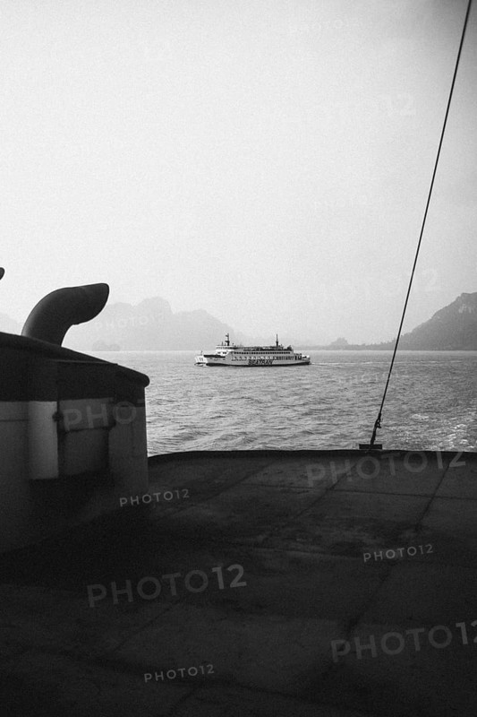 View of a passing ship from the deck in high-contrast black and white. Surat Thani, Thailand, Asia