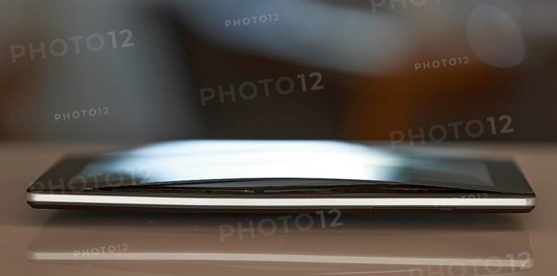 A defective, swollen battery pushes the housing of a tablet apart, damaging the display