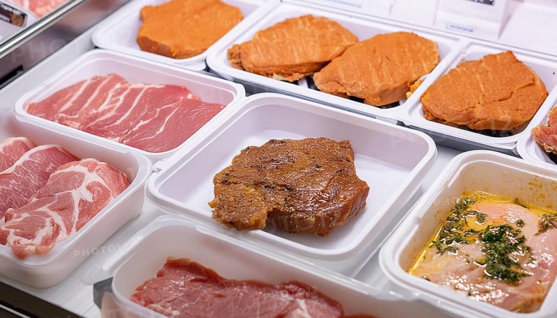 Meat, raw pork, schnitzel and steak, marinated and seasoned, in a display in a butcher's shop, AI generated, AI generated