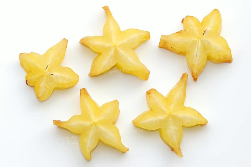 Star fruit or carambola (Averrhoa carambola), sliced fruit on a white background