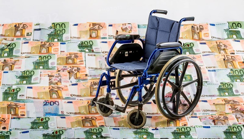 Symbolic long-term care insurance, care costs, disability, a wheelchair stands on a surface of euro notes, money, AI generated, AI generated