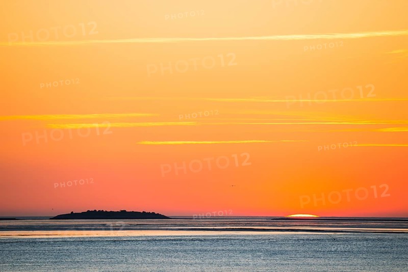 Picturesque, golden, breathtakingly beautiful sunset over the sea, last moments in front of the sun sets in the sea, narrow crescent, island Langluetjen II on the horizon, orange glowing cloudless sky, wide sea in soft colours, mouth of the Weser into the North Sea, Outer Weser, Bremerhaven, Land Bremen, Germany, Europe