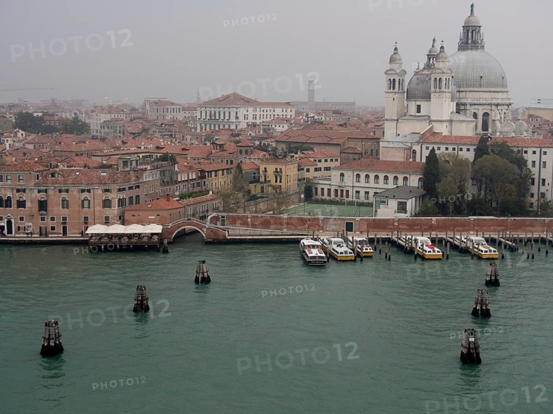 Foggy day in Venice, cathedral and historic buildings along the canal, church towers and historic buildings along a large canal, view of Venice from the water, Venice, Italy, Europe
