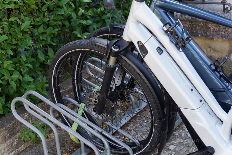 Electric bicycles parked and locked with a padlock