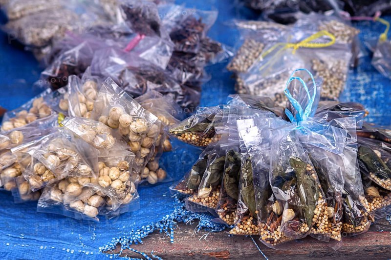 Assorted plastic bags of different dried spices and herbs like Aleurites moluccanus or candlenut, laurel leaves, pepper and star anise that are use as traditional alternative medicines in North Sumatra, Indonesia, Asia