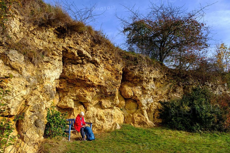Hiker at the Burschel geotope, Riesse limestones, Hainsfarth, Ries crater rim, Noerdlinger Ries, Swabia, Bavaria, Germany, Europe