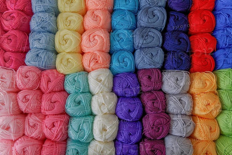 Close-up of a group of balls of colored wool with a pattern
