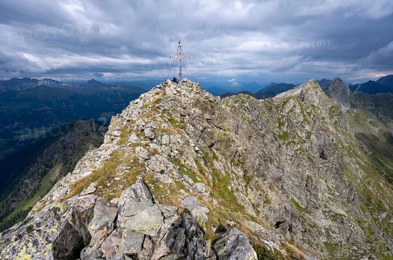 Rocky pointed summit of the Raudenspitze or Monte Fleons with summit cross, mountain panorama on the Carnic main ridge, Carnic Alps, Carinthia, Austria, Europe