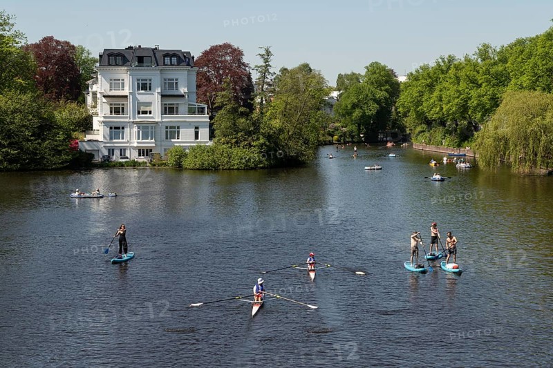 Symbolic picture weather, leisure activity, summery spring, villa at the Krugkoppelbruecke with rowing boats, pedal boats and stand up paddling in front of a blue sky on the Alster in Hamburg, Germany, Europe