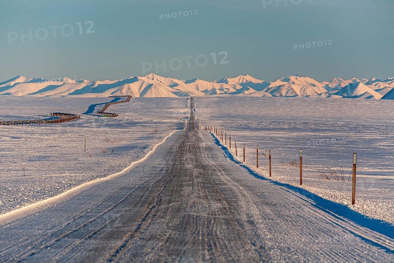 Icy gravel road in winter, Dalton Highway, Trans Alaska Pipeline, Brooks Range, Alaska, USA, North America