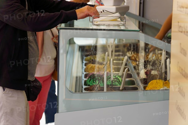 Customers buying ice cream in an ice cream parlor on the street