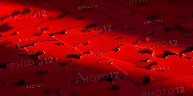 Illustration of scattered red puzzle pieces sprawled across as a wallpaper background, AI generated
