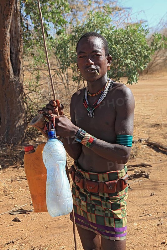 South Ethiopia, Omo region, man from the Karo people with water bottles, plastic bottles filled with water, Ethiopia, Africa