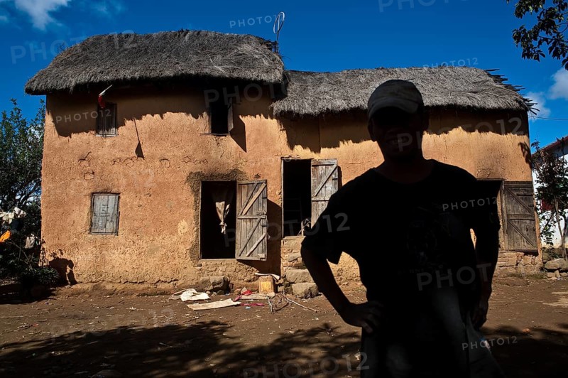 Portrait of a man belonging to the Betsileo ethnic group, standing in front of his house, Ambositra, Madagascar, Africa