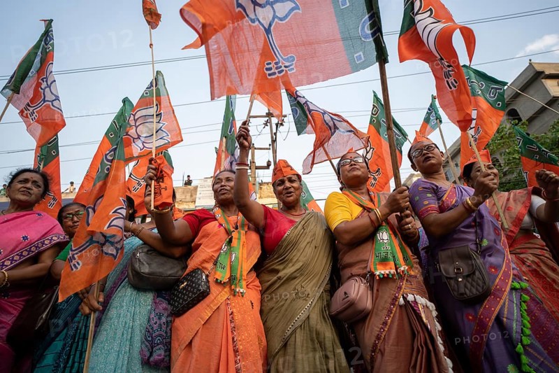 Bharatiya Janata Party (BJP) supporters dancing as they arrives to to see a roadshow of Union Home minister Amit Shah, ahead of third phase of General Elections, in Guwahati, Assam, India on 29 April 2024