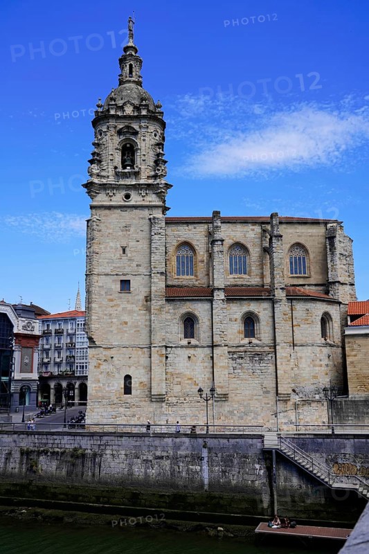 The church Iglesia de San Anton at the river Nervion in Bilbao, Historic church with stone bell tower in front of a sunny, blue sky, The church Iglesia de San Anton at the river Nervion in Bilbao. Built in 1510, the church is a Catholic place of worship in the old town centre. It is built in the Gothic style with Baroque elements, BILBAO, Spain, Europe