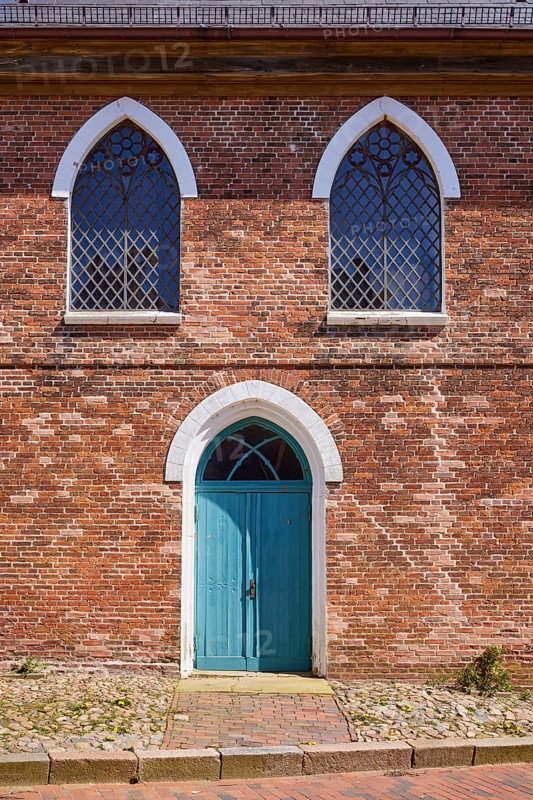 Arched windows and door to St Laurentius Church in Toenning, North Friesland district, Schleswig-Holstein, Germany, Europe