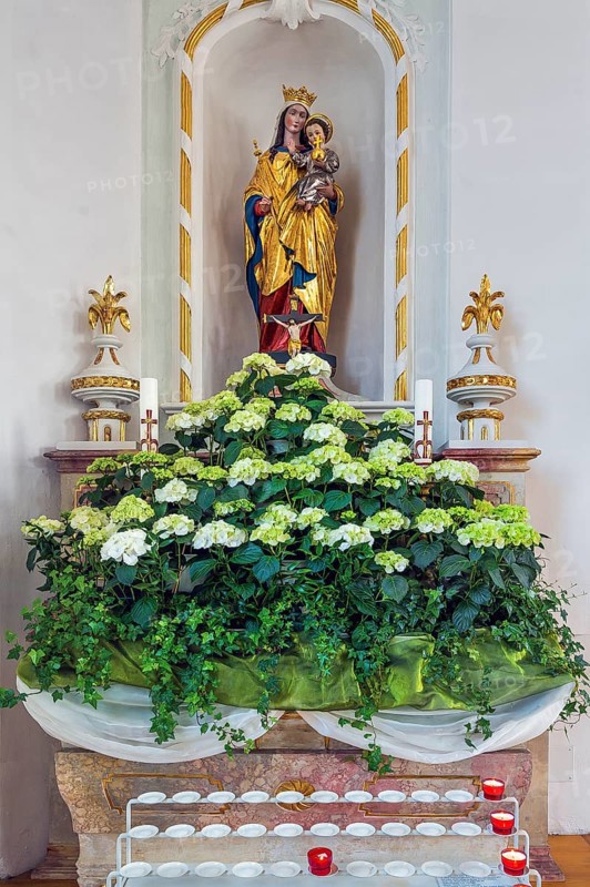 Side altar with Marian figure, floral decoration and sacrificial candles, Kronburg branch church, Kronburg, Allgaeu, Swabia, Bavaria, Germany, Europe