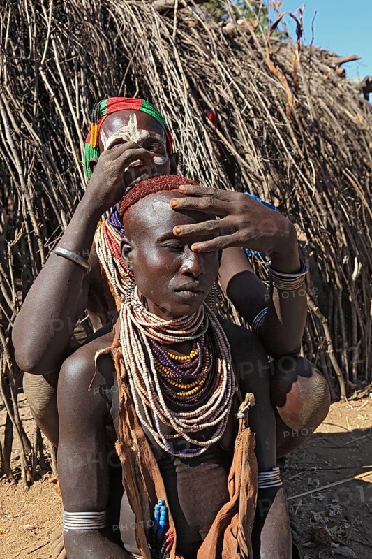 South Ethiopia, Omo region, among the Karo people, woman with jewellery and face painting styling their hair, Ethiopia, Africa