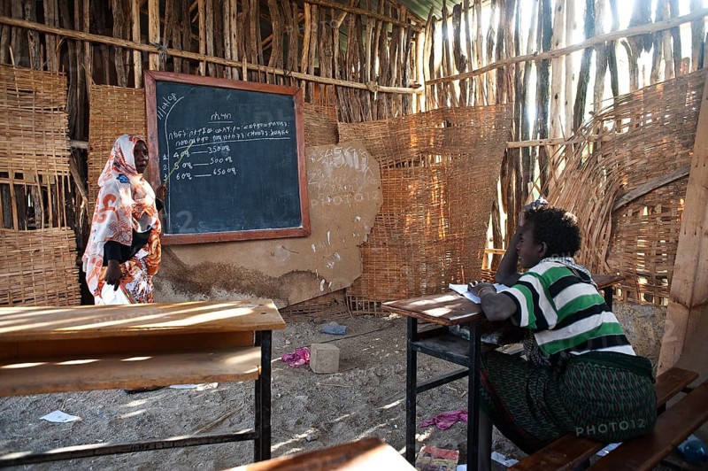 Muslim female teacher teaching mathematics, school in a remote village inhabited by the Afar tribespeople, Ethiopia, Africa
