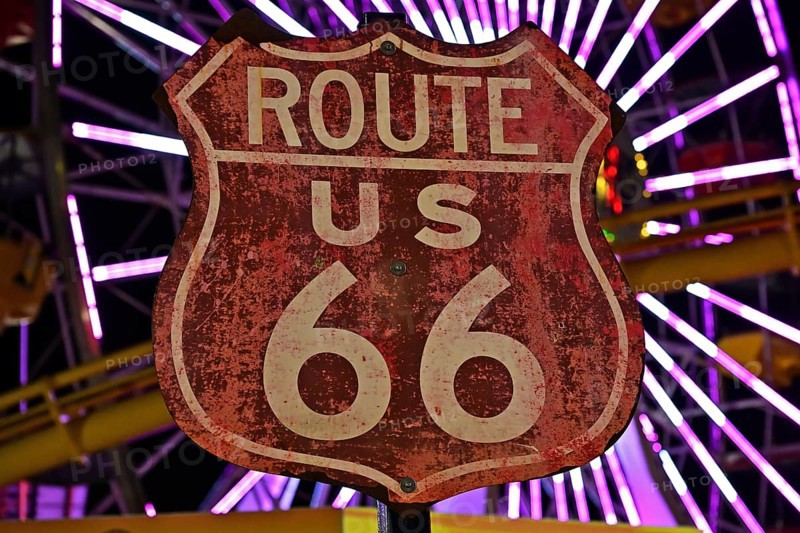 Route 66 sign in front of the Ferris wheel on the pier in Santa Monica, California