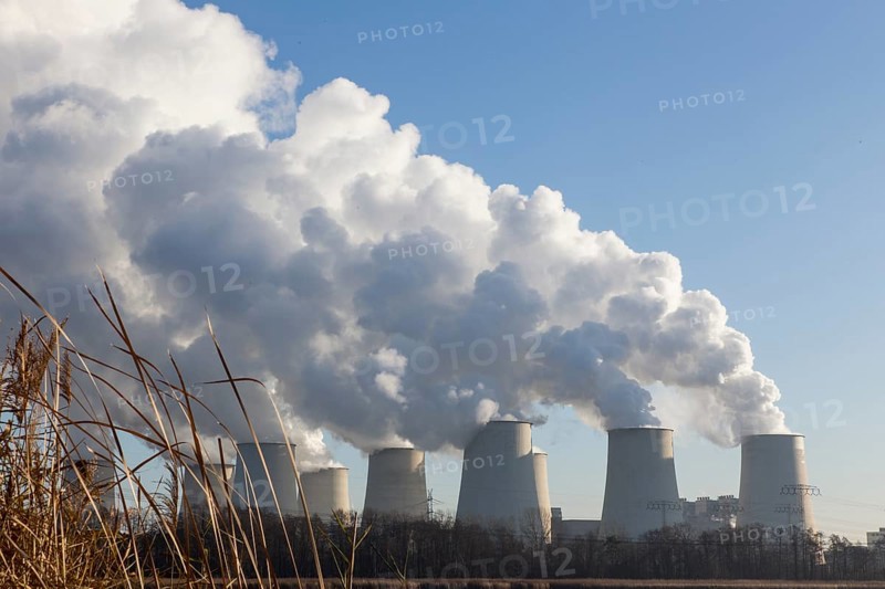 Steam rises from the cooling towers of the Vattenfall power plant in Jaenschwalde, power lines and electricity pylons at the power plant on 9 December 2014. The energy company Vattenfall mines lignite to generate electricity in the surrounding opencast mines in Brandenburg, Jaenschwalde, Germany, Europe