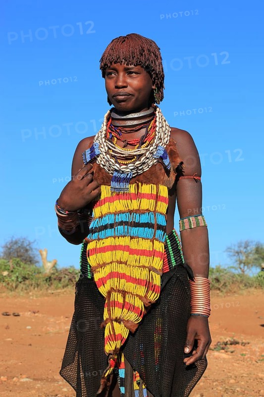 South Ethiopia, Omo region, young woman of the Hammer people, wears a lot of jewellery and her hair is dyed with a mixture of ochre clay and fat, Ethiopia, Africa