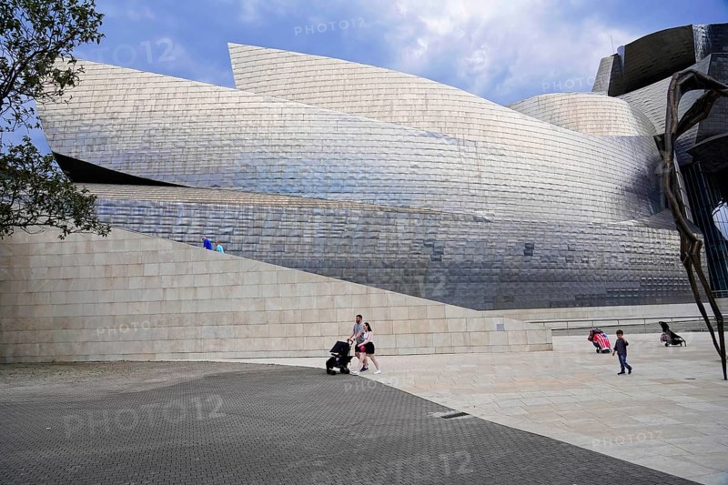Guggenheim Museum Bilbao on the banks of the Nervion River, architect Frank O. Gehry, Bilbao, A modern art museum with striking architectural design, people exploring the surroundings and a large spider sculpture, Guggenheim Museum, architect Frank O. Gehry, Bilbao, Bizkaia Province, Basque Country, Spain, Europe