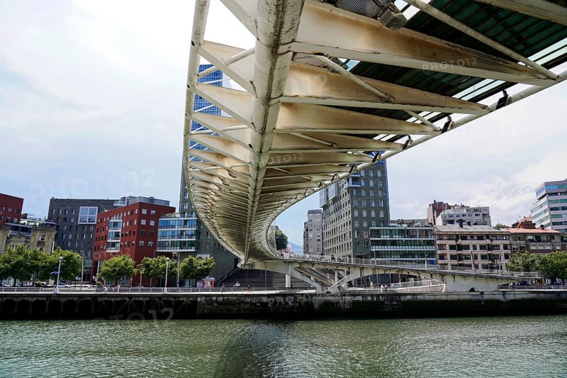 Pedestrian bridge Zubizuri, White Bridge, Bilbao, bottom view of a modern bridge over a river Nervion, skyscrapers in the background, old town, Bilbao, Basque Country, Spain, Europe