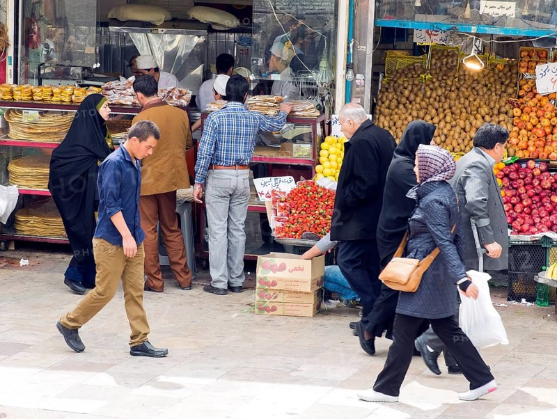 Iranians walk past stalls selling fruit and vegetables at a bazaar in Tehran, 29/03/2015, Tehran, Iran, Asia