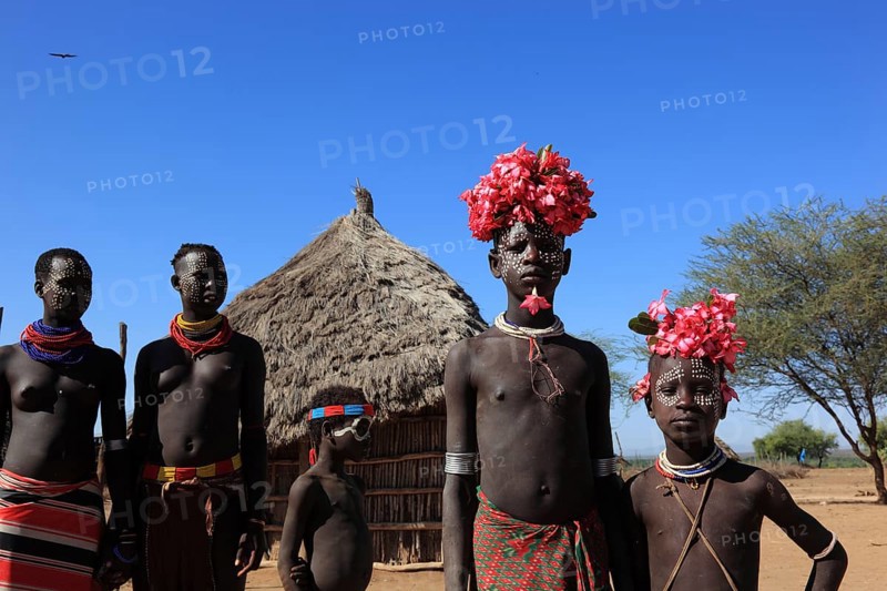 South Ethiopia, Omo region, tribal members of the Karo people, with floral decorations and body painting, Ethiopia, Africa