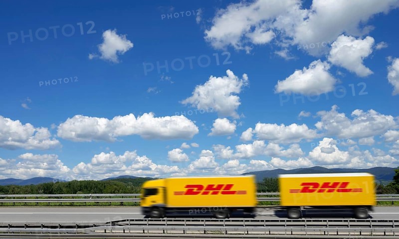 A DHL lorry drives past Deggendorf on the A3 motorway, with the Bavarian Forest in the background, Bavaria, Germany, Europe