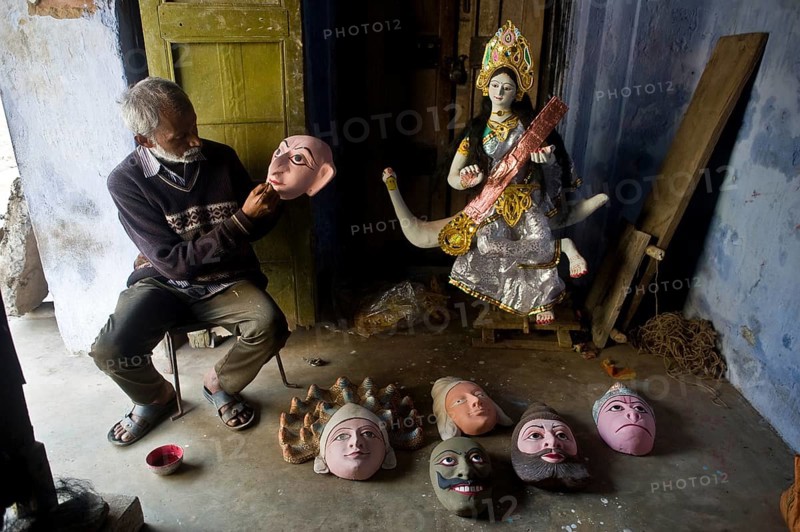 Craftsman making masks, masks used for the Seraikela Chhau dance, Jharkhand, India. Representation of the hindu deity Saraswati, the goddess of knowledge, music and arts