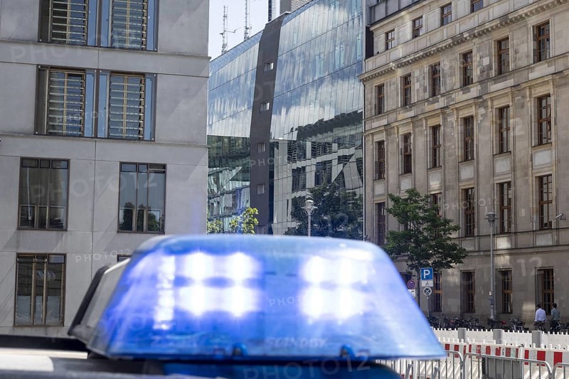 Blue light of a police vehicle in front of the German Bundestag with the Jakob Kaiser House in the background in Berlin, 16 May 2024
