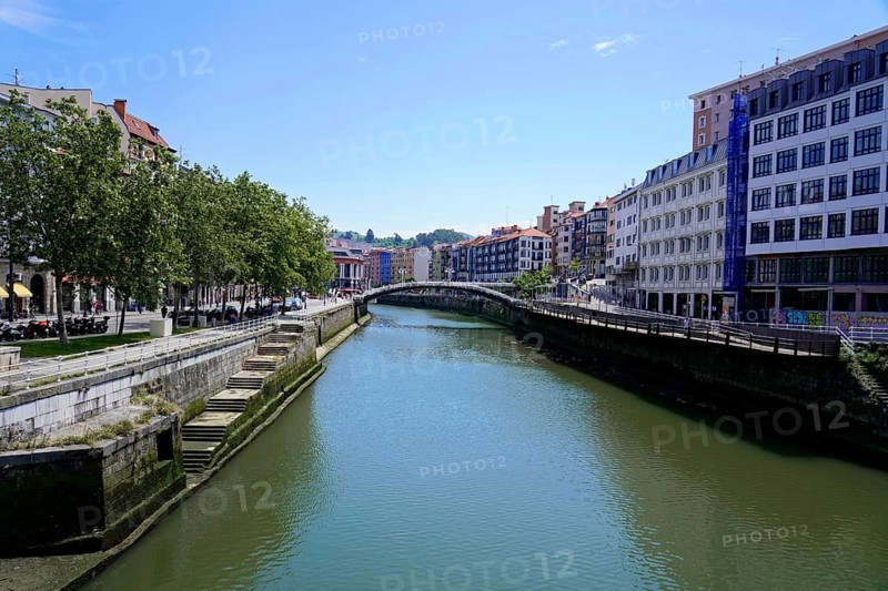 On the road in Bilbao, Bizkaia Province, Basque Country, Spain, Europe, River Nervion, through a city with multi-storey buildings and trees along the banks, old town, Bilbao, Europe
