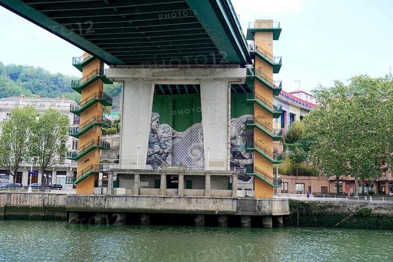 La Salve Bridge, A bridge with artistic graffiti on concreted pillars over a river Nervion, in the city, old town, Bilbao, Basque Country, Spain, Europe