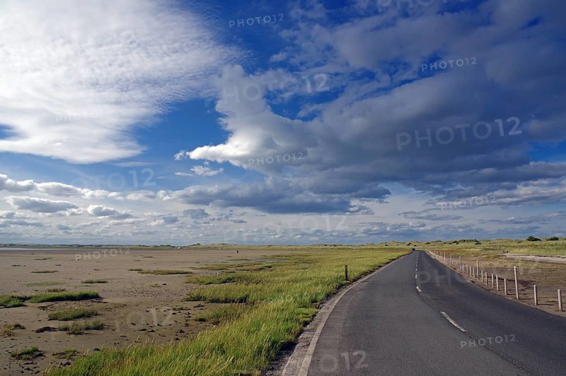 Road leads through tidal landscapes at low tide, Lindisfarne, Northumberlands, England, Great Britain